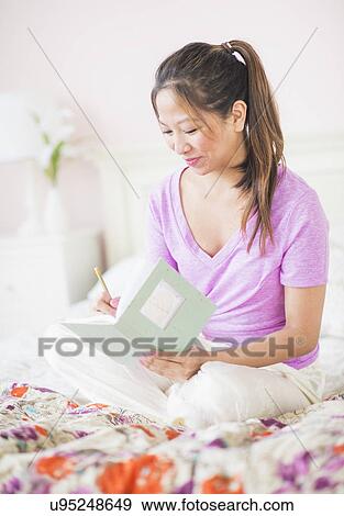 Stock Photo - Young woman writing. Fotosearch
