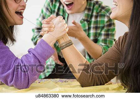 Young women and man arm wrestling View Large Photo Image Stock Image - Young women and man arm wrestling. Fotosearch