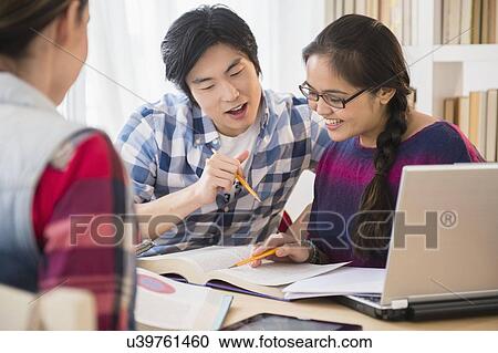 Young women and man studding in library View Large Photo Image Stock Image - Young women and man studding in library. Fotosearch