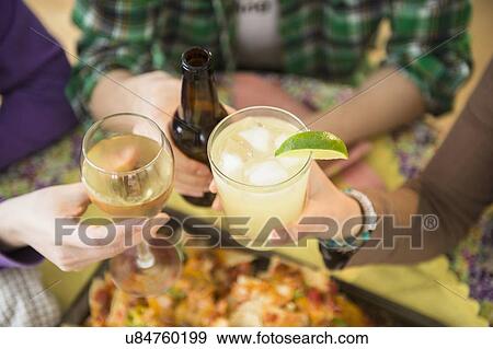Young women and man toasting View Large Photo Image Stock Photo - Young women and man toasting. Fotosearch