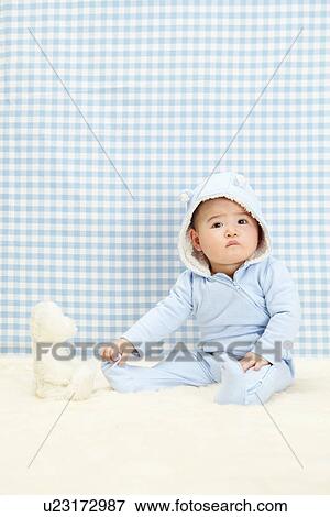Baby boy sitting with soft toy View Large Photo Image Stock Photo - Baby boy sitting with soft toy. Fotosearch