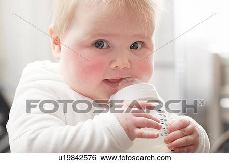 Baby girl drinking baby bottle View Large Photo Image Stock Photograph - Baby girl drinking baby bottle. Fotosearch
