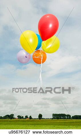 Balloons floating in the air View Large Photo Image Stock Photo - Balloons floating in the air. Fotosearch
