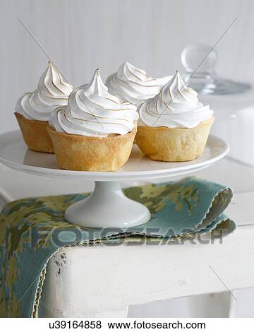 Stock Photo - Banana meringue tarts on cake stand. Fotosearch