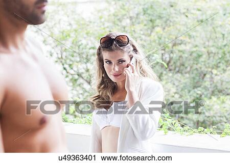 Bare chested man and young woman on cellphone View Large Photo Image Stock Image - Bare chested man and young woman on cellphone. Fotosearch