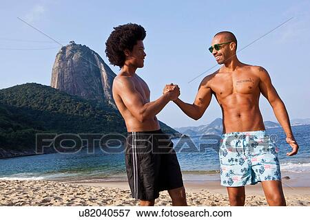 Best friends on beach shaking hands, Rio de Janeiro, Brazil View Large Photo Image Stock Photo - Best friends on beach shaking hands, Rio de Janeiro, Brazil. Fotosearch