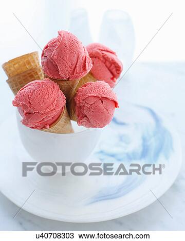 Stock Image - Bowl of ice cream cones filled with strawberry ice cream. Fotosearch