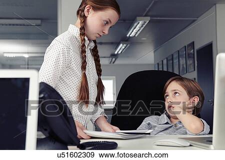 Boy at desk with disapproving girl View Large Photo Image Stock Photo - Boy at desk with disapproving girl. Fotosearch