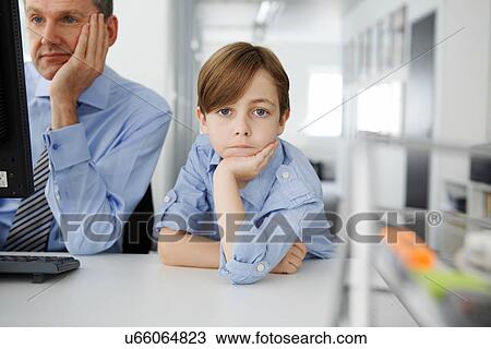 Boy leaning on elbow, father using computer View Large Photo Image Stock Image - Boy leaning on elbow, father using computer. Fotosearch