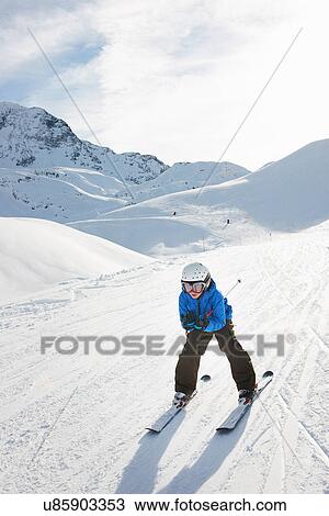 Boy skiing downhill, Les Arcs, Haute-Savoie, France View Large Photo Image Stock Image - Boy skiing downhill, Les Arcs, Haute-Savoie, France. Fotosearch