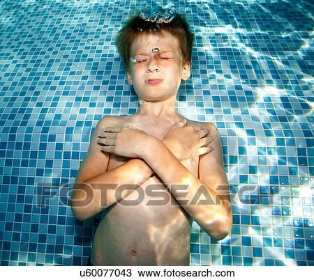 Boy underwater in swimming pool View Large Photo Image Stock Image - Boy underwater in swimming pool. Fotosearch