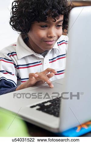 Boy using laptop View Large Photo Image Stock Image - Boy using laptop. Fotosearch