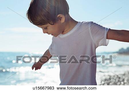 Boy with arms outstretched on beach View Large Photo Image Stock Image - Boy with arms outstretched on beach. Fotosearch