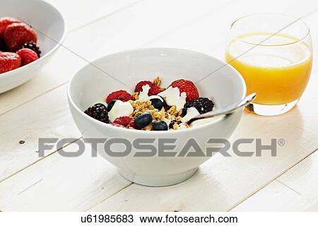 Breakfast cereal with fresh berries and orange juice View Large Photo Image Stock Image - Breakfast cereal with fresh berries and orange juice. Fotosearch