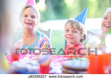 Brother and his sisters enjoying birthday View Large Photo Image Stock Photo - Brother and his sisters enjoying birthday. Fotosearch