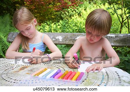 Brother and sister drawing in garden View Large Photo Image Stock Image - Brother and sister drawing in garden. Fotosearch