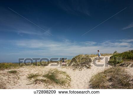 Brother and sister running over sand dunes View Large Photo Image Stock Photo - Brother and sister running over sand dunes. Fotosearch