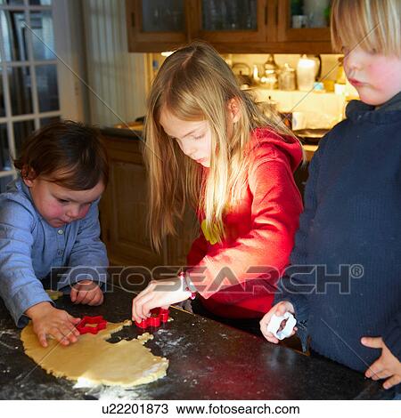 Brother and sisters making biscuits in kitchen View Large Photo Image Stock Image - Brother and sisters making biscuits in kitchen. Fotosearch