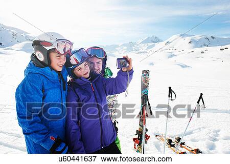 Brother and sisters taking self portrait, Les Arcs, Haute-Savoie, France View Large Photo Image Stock Photo - Brother and sisters taking self portrait, Les Arcs, Haute-Savoie, France. Fotosearch