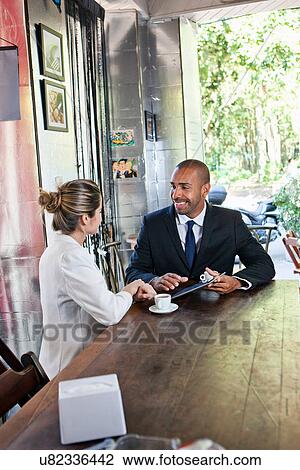 Business man and woman in cafe with digital tablet View Large Photo Image Stock Image - Business man and woman in cafe with digital tablet. Fotosearch
