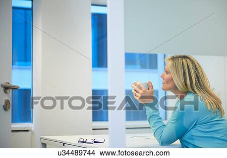 Businesswoman working late at office View Large Photo Image Picture - Businesswoman working late at office. Fotosearch