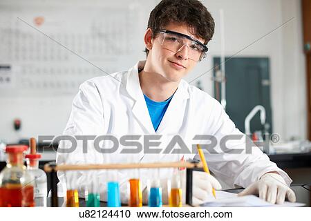 Stock Image - Chemistry student doing experiment. Fotosearch