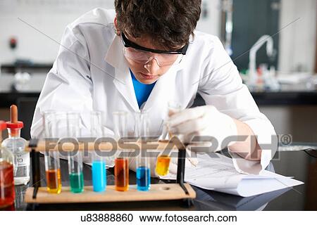 Stock Image - Chemistry student doing experiment. Fotosearch