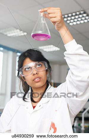 Stock Photo - Chemistry student holding conical flask. Fotosearch
