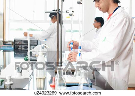 Stock Photo - Chemistry students doing experiment. Fotosearch