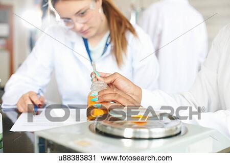 Chemistry students weighing chemicals on scales View Large Photo Image Stock Image - Chemistry students weighing chemicals on scales. Fotosearch