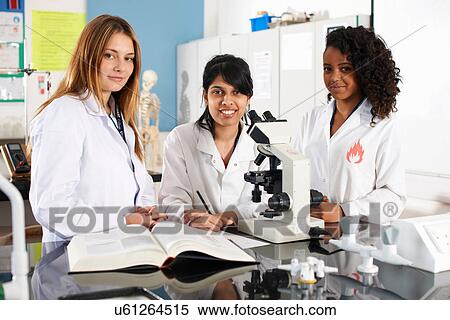 Chemistry students with microscope in laboratory View Large Photo Image Stock Photography - Chemistry students with microscope in laboratory. Fotosearch