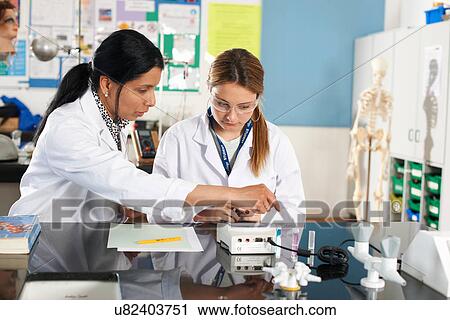Chemistry teacher and student in laboratory View Large Photo Image Stock Image - Chemistry teacher and student in laboratory. Fotosearch