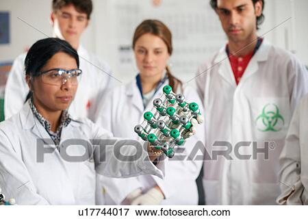 Chemistry teacher and students holding molecular model View Large Photo Image Stock Photo - Chemistry teacher and students holding molecular model. Fotosearch