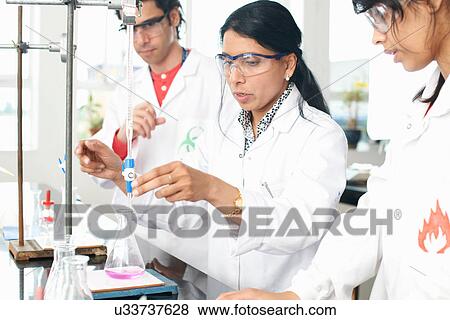 Chemistry teacher doing experiment with students View Large Photo Image Stock Photo - Chemistry teacher doing experiment with students. Fotosearch