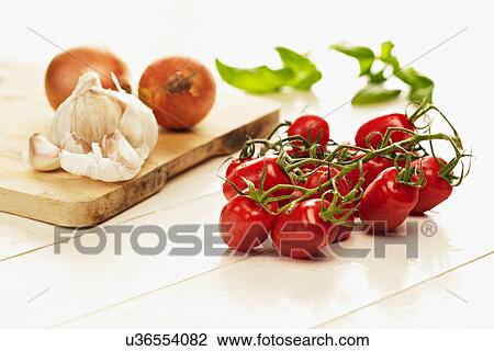 Cherry tomatoes, garlic and onion still life View Large Photo Image Stock Image - Cherry tomatoes, garlic and onion still life. Fotosearch