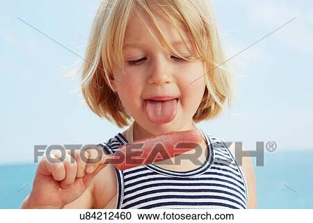 Child about to lick ice lolly View Large Photo Image Stock Image - Child about to lick ice lolly. Fotosearch