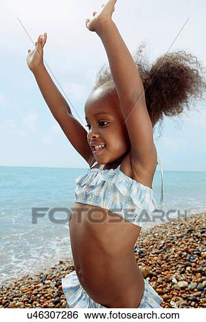 Child playing on beach View Large Photo Image Stock Photograph - Child playing on beach. Fotosearch