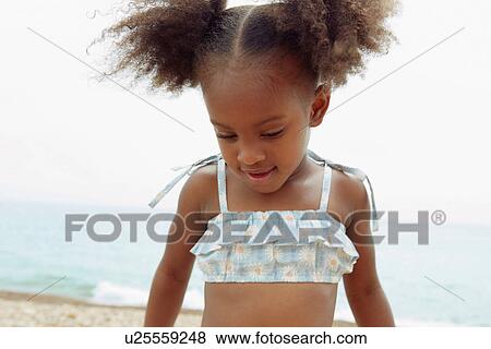 Stock Photo - Child walking on beach. Fotosearch