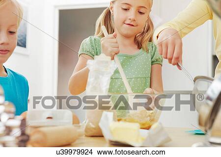 Children baking, mixing ingredients View Large Photo Image Picture - Children baking, mixing ingredients. Fotosearch