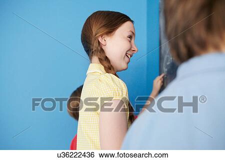 Children writing on blackboard, blue background View Large Photo Image Stock Photograph - Children writing on blackboard, blue background. Fotosearch