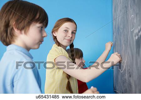 Children writing on blackboard, blue background View Large Photo Image Stock Photography - Children writing on blackboard, blue background. Fotosearch