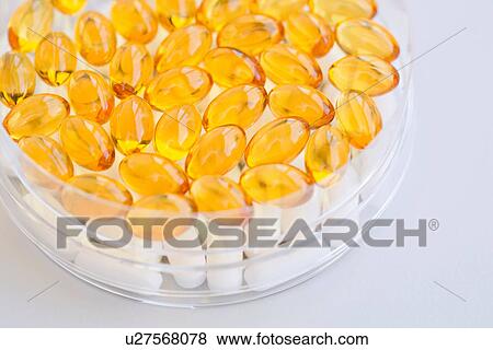 Close up of fish oil capsules in petri dish View Large Photo Image Stock Photo - Close up of fish oil capsules in petri dish. Fotosearch