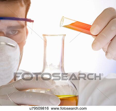 Close up of scientist pouring liquid from test tube View Large Photo Image Stock Photograph - Close up of scientist pouring liquid from test tube. Fotosearch