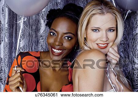 Close up of two young women holding balloons View Large Photo Image Stock Image - Close up of two young women holding balloons. Fotosearch