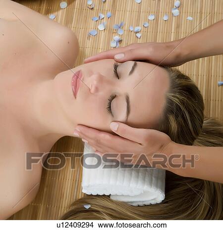 Picture - Close up of woman having head massage. Fotosearch