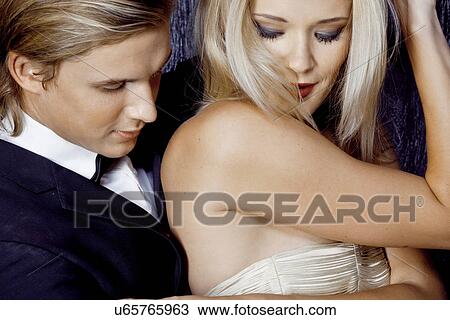 Close up of young glamorous couple flirting View Large Photo Image Stock Image - Close up of young glamorous couple flirting. Fotosearch