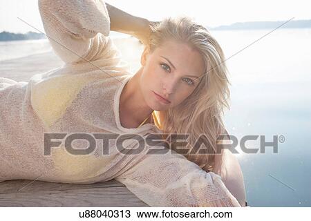 Close up of young woman posing on lake pier View Large Photo Image Stock Image - Close up of young woman posing on lake pier. Fotosearch