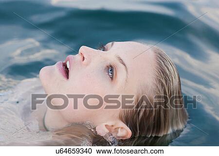 Close up portrait of young woman submerged in lake View Large Photo Image Stock Image - Close up portrait of young woman submerged in lake. Fotosearch