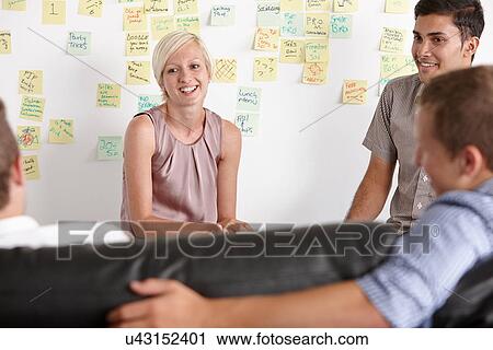 Colleagues having discussion View Large Photo Image Stock Image - Colleagues having discussion. Fotosearch