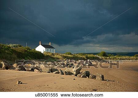 Cottage by beach, Devon, England, UK View Large Photo Image Stock Photography - Cottage by beach, Devon, England, UK. Fotosearch